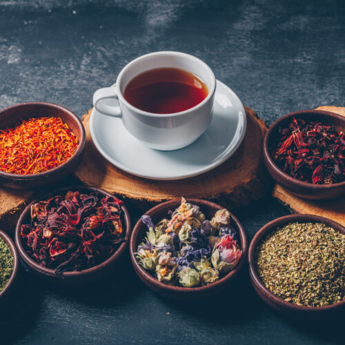 tea-herbs-bowls-with-wood-stubs-cup-tea-high-angle-view-dark-textured-background-space-text (2)